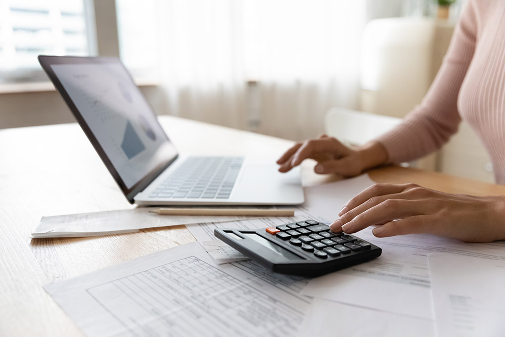 Woman calculating bills she owes